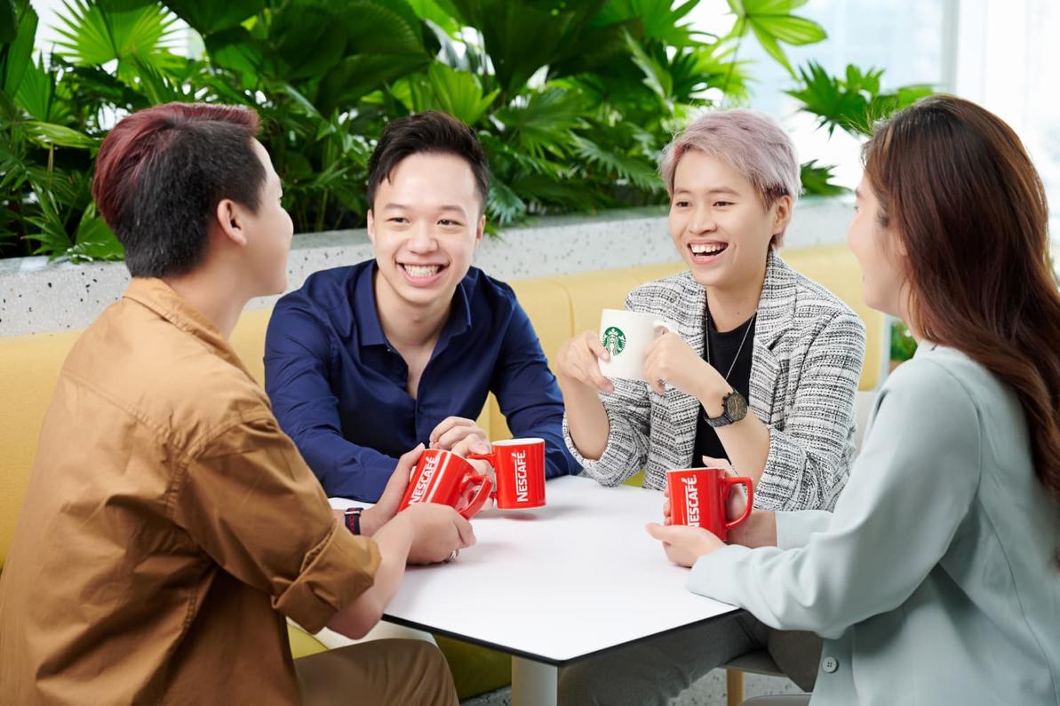 group-employees-at-table-smiling